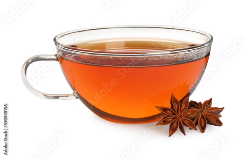 Glass cup of hot tea with anise stars on white background