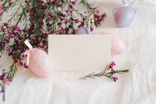 Easter eggs with flowers on white linen fabric. Spring and Easter concept.