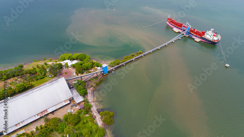 Cargo ship being loaded with alcohol in port