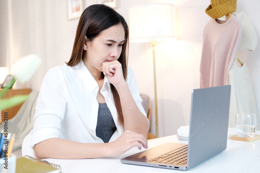 Young asian woman stress while working with laptop computer at home office Young asian woman stress while working with laptop computer at home office