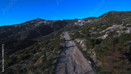 Flying over gravel road on Pentelicus mount in Athens Greece photo