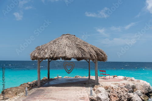 Palm leaf palapa on the shore of a beach to protect from the sun on the island of Cura  ao. Netherlands Antilles.