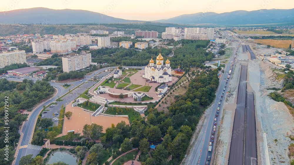 Gelendzhik, Russia. Cathedral of St. Andrew. The text along the M4-Don Highway is translated: Glory to Russia, Kuban-Pearl of Russia. Gelenzhik-City Resort. Sunset, Aerial View
