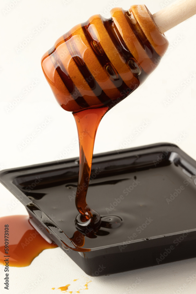 Bracatinga honey on wooden dipper isolated on white. Healthy organic food. Bracatinga honey on wooden dipper isolated on white. Healthy organic food.