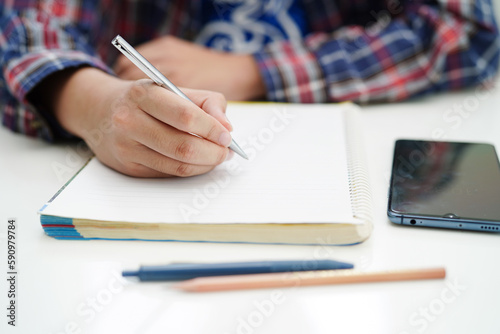 Asian teenage student write homework, study lesson for exam online learning education.
