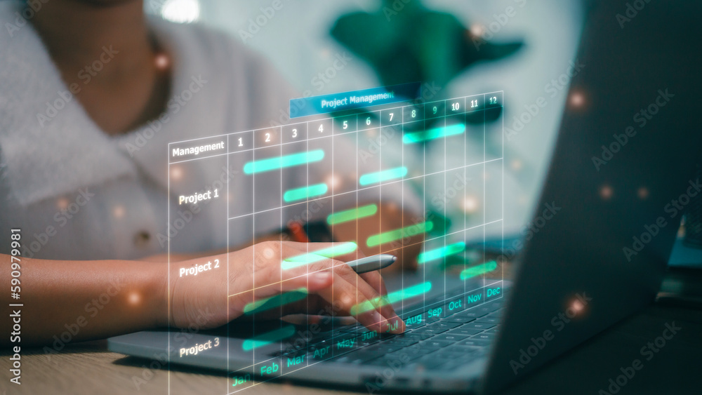 Business Project Management System. Project manager working on laptop and updating tasks and milestones progress planning with Gantt chart scheduling interface for the company on virtual screen.