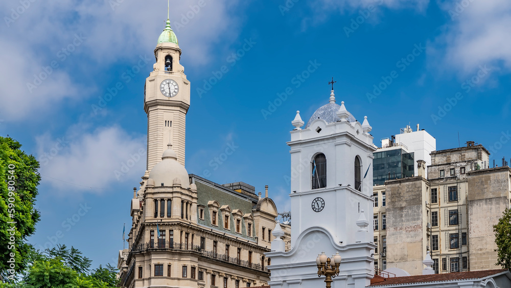 The architecture of the historic district of Buenos Aires. Ancient stone buildings with towers, domes, spires, clocks against the blue sky. Argentina