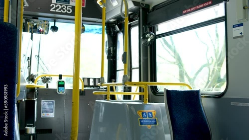 front seats for people with disabilities folding seats empty bus no people follows the schedule along the route Vancouver BC, Canada 2023 Tap machine inside the translink bus is out of order photo