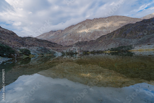 mountains, clouds and sky are reflected on the lake. Beautiful scenery at Yarab Tso valley - Leh Ladakh - India