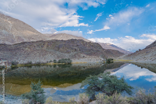 mountains, clouds and sky are reflected on the lake. Beautiful scenery at Yarab Tso valley - Leh Ladakh - India