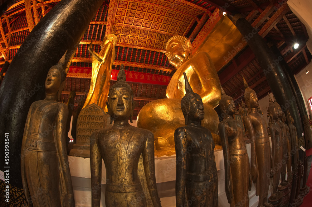 Fototapeta premium Groups of ancient Buddha images of various sizes gathered from various abandoned temples in Luang Prabang beside Luang Phor Tor in Wat Visounarath. Located at Luang Prabang Province in Northern Laos.