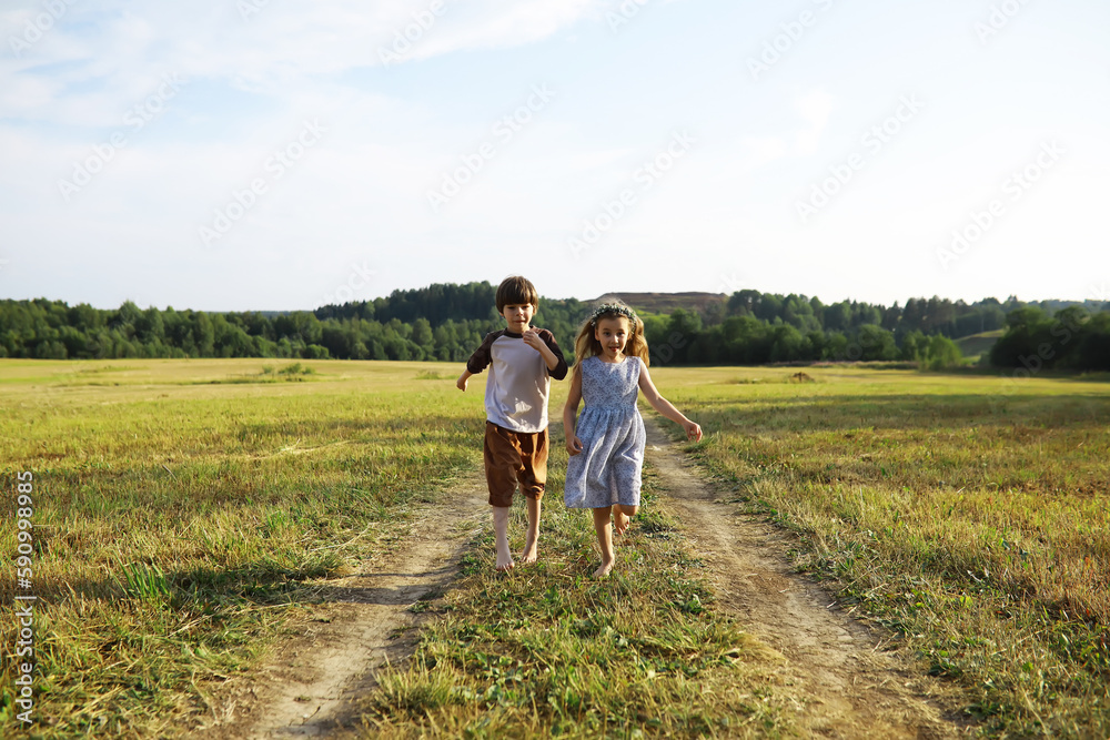 Children walk in the summer in nature. Child on a sunny spring morning in the park. Traveling with children.