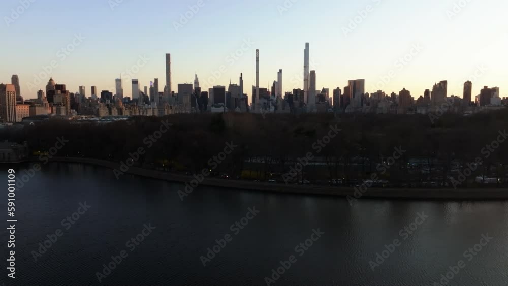 Aerial view of the reservoir and the Central park with Midtown skyscraper background - rising, drone shot Aerial view of the reservoir and the Central park with Midtown skyscraper background - rising, drone shot