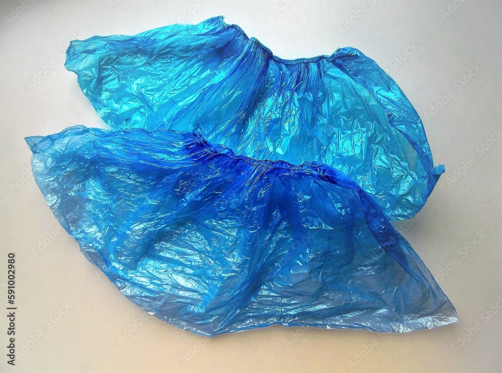 Fototapeta premium blue hygienic shoe covers on a light background
