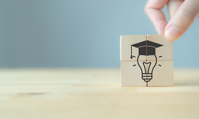 Graduation from university, education, diploma concept. Commencement, Graduation day. Personal competency development. Wooden cubes with graduation cap on beautiful grey background and copy space.