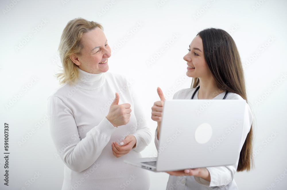 young female patient on bed showing thumbs up with smiley face very good symptom to asian young female doctor in hospital background. High quality photo young female patient on bed showing thumbs up with smiley face very good symptom to asian young female doctor in hospital background. High quality photo