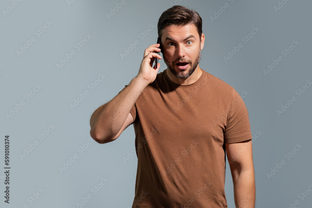 Satisfied business man talking on phone, promo mobile app. Businessman in casual clothes using smartphone isolated on studio background. Portrait of cheerful guy using cellphone, browse social media.