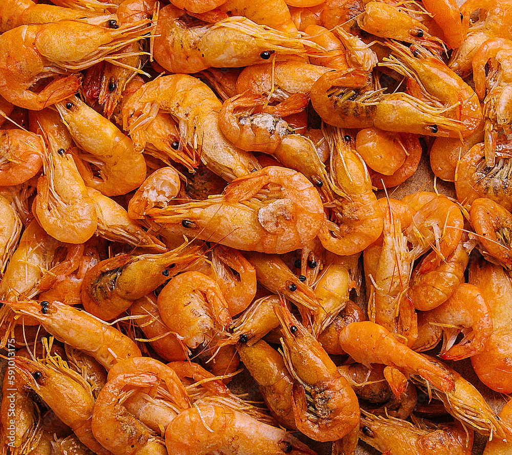 Small cooked shrimp on wooden tray