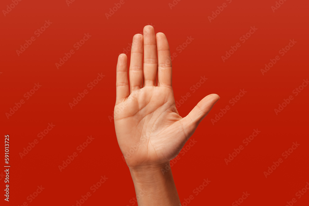 white woman making stop sign with her hand, on red background white woman making stop sign with her hand, on red background