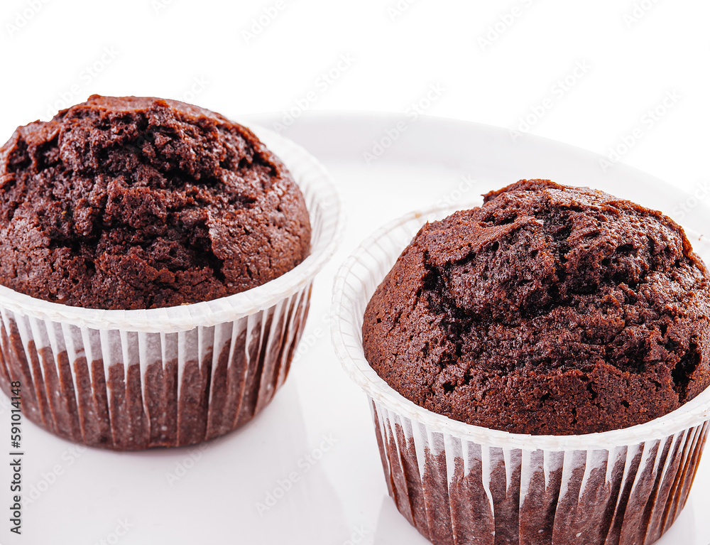 Chocolate cupcakes on a plate isolated on white Chocolate cupcakes on a plate isolated on white