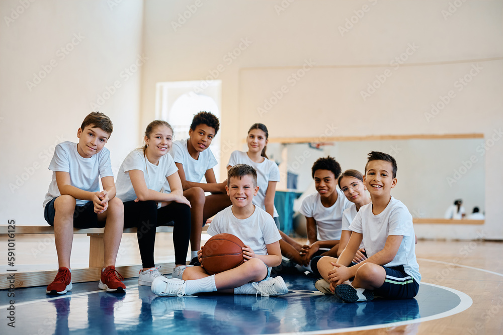 Multiracial group of happy kids having physical activity class at school gym and looking at camera. Multiracial group of happy kids having physical activity class at school gym and looking at camera.