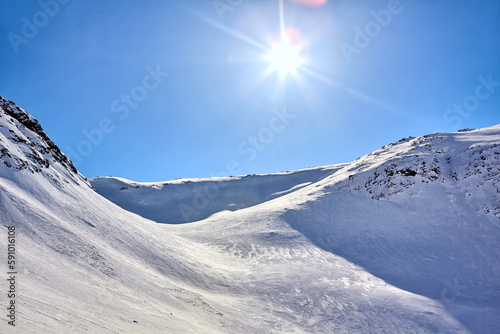 East Greenland Landscape with mountains, snow and sun