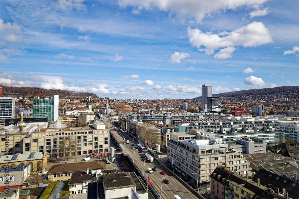 Aerial view of skyline of Industrial district of City of Zürich with multi line highway on a blue cloudy winter noon. Photo taken March 9th, 2023, Zurich, Switzerland.