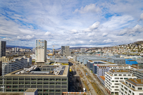 Aerial view of skyline of Industrial district of City of Zürich with Limmat Valley in the background on a blue cloudy winter noon. Photo taken March 9th, 2023, Zurich, Switzerland. photo