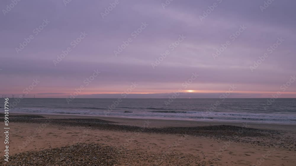 Timelapse shot of waves crashing on to a sandy beach during morning time in Great Yarmouth, UK. Timelapse shot of waves crashing on to a sandy beach during morning time in Great Yarmouth, UK.