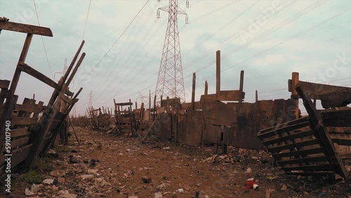 wooden kraal for cattle under a high tension electricity pole with pollution in Africa photo