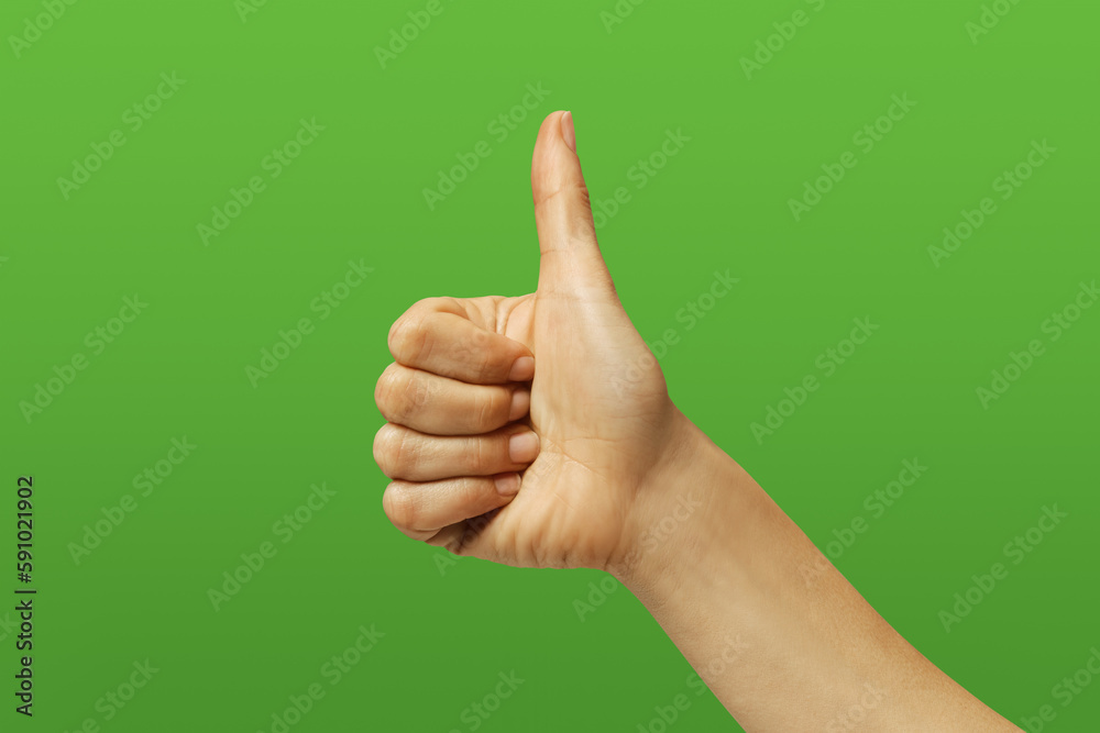 woman's hand making the ok sign, on green background