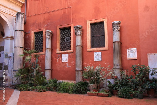 San Silvestro in Capite Church Courtyard with Red Wall and Ancient Columns in Rome, Italy photo