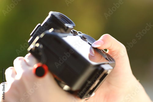 Close up of a photographer hand setting camera