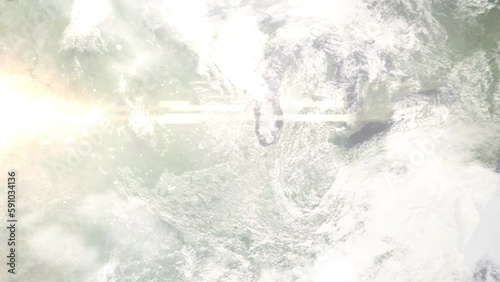 Earth zoom in from outer space to city. Zooming on Wheaton, Illinois, USA. The animation continues by zoom out through clouds and atmosphere into space. Images from NASA photo