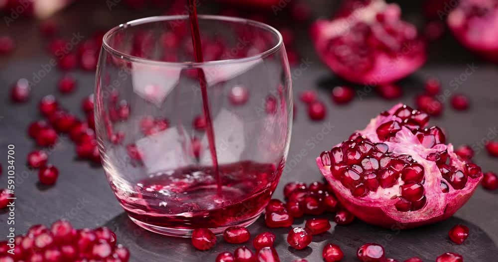 Natural pomegranate juice with red juicy pomegranate seeds on the board, delicious sweet pomegranate juice with whole pomegranate seeds scattered on the table Natural pomegranate juice with red juicy pomegranate seeds on the board, delicious sweet pomegranate juice with whole pomegranate seeds scattered on the table