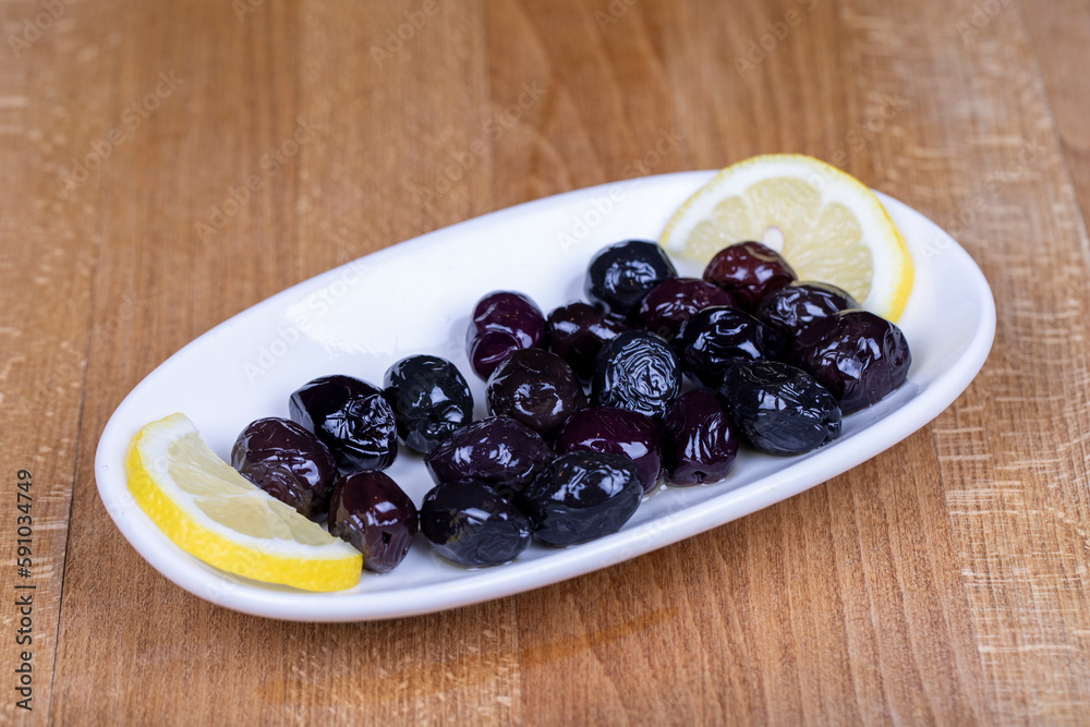 Black olive. Naturally black olive in a ceramic bowl. Close up