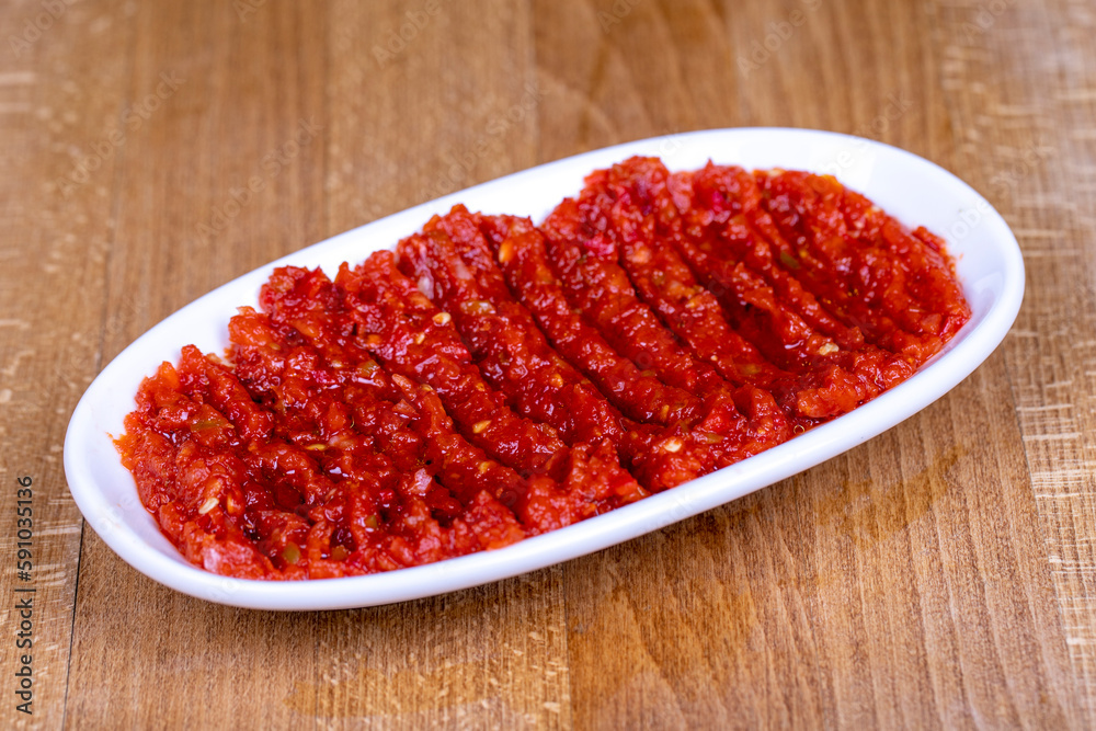 Chili paste. Hot snack prepared with pepper paste in a ceramic bowl. close up Chili paste. Hot snack prepared with pepper paste in a ceramic bowl. close up