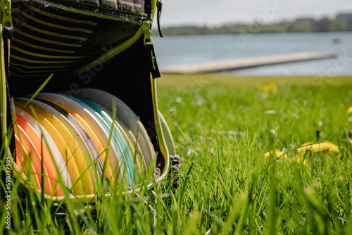 discgolf bag in the grass with yellow flowers photo