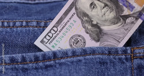 take cash American hundred dollar bills lying in the pocket of jeans, American dollars close-up