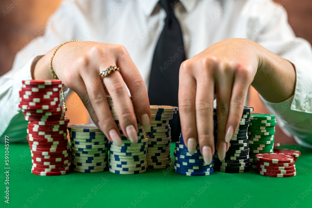 woman in a classic white shirt and tie at the poker table starts the game. woman in a classic white shirt and tie at the poker table starts the game.