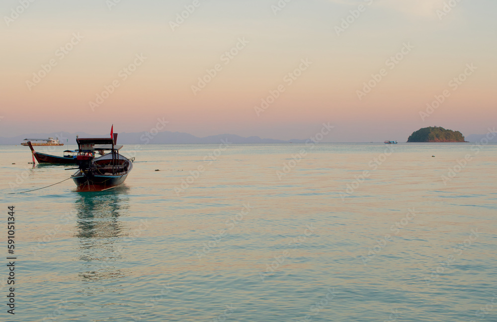 Artisanal fishery boat with sunset sky