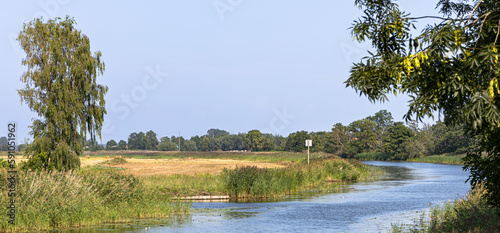 Szkarpawa river, Rybina village, northern Poland photo