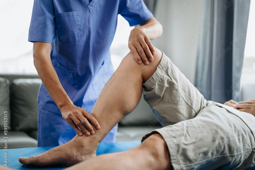 Close up of Physiotherapist working with patient on the bed. Close up of Physiotherapist working with patient on the bed.