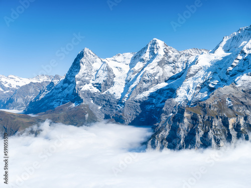 Mountain scenery in the Swiss Alps. Mountains peaks. Natural landscape. Mountain range and clear blue sky. Landscape in the summertime.
