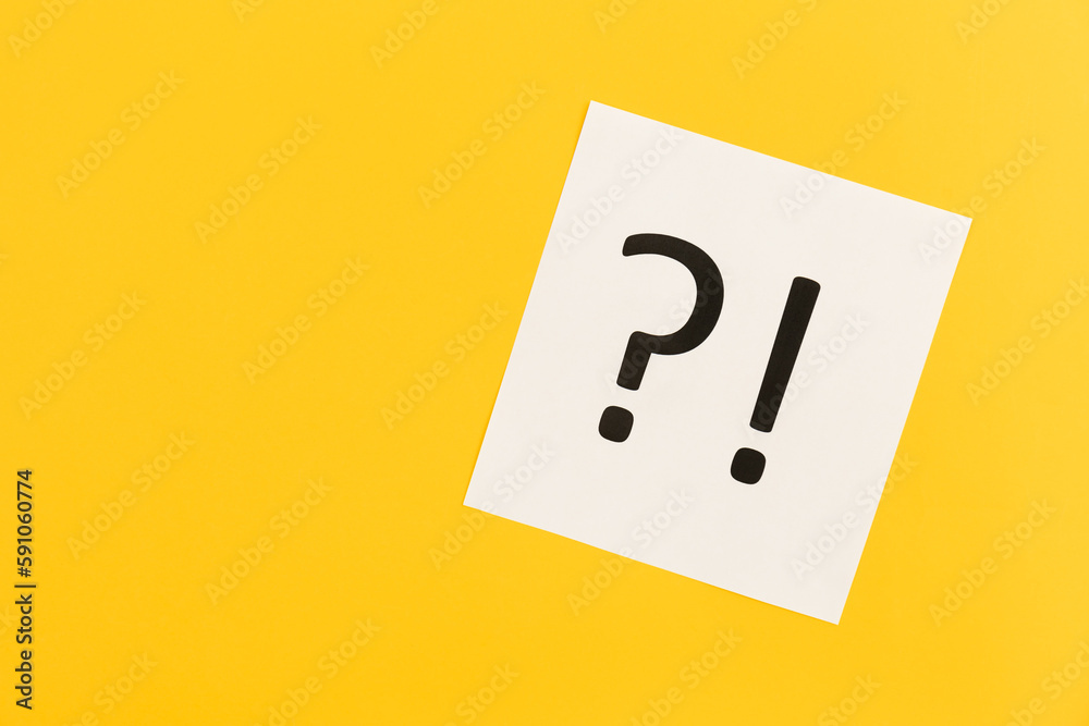 Question mark and exclamation mark on yellow background, flat lay. Question mark and exclamation mark on yellow background, flat lay.