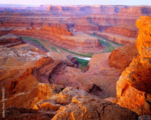 Scenic view of the dead horse point in a desert filled with cliffs during an orange sunset in Utah