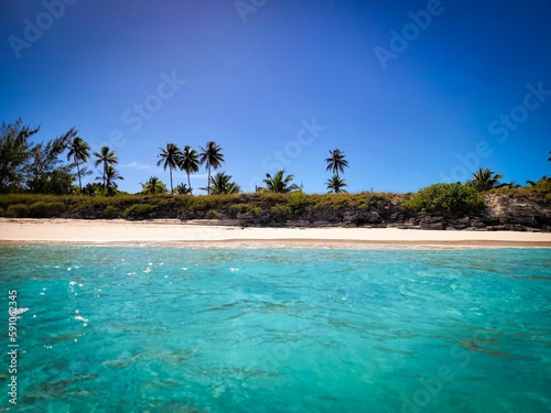 Scenic view of a small tropical island with lush nature surrounded by the sea