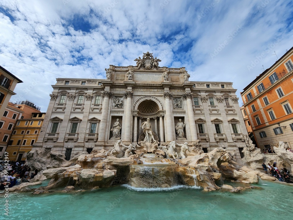 Trevi fountain in Rome, Italy against the cloudy sky