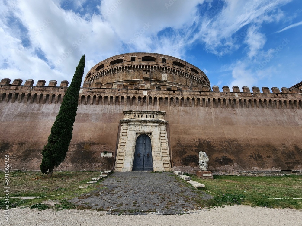 Low angle of Castle Sant Angelo Mausoleum in Rome, Italy under blue sky