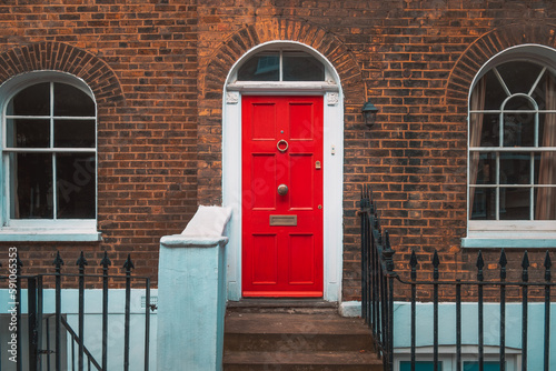 Vintage red door with brick wall.